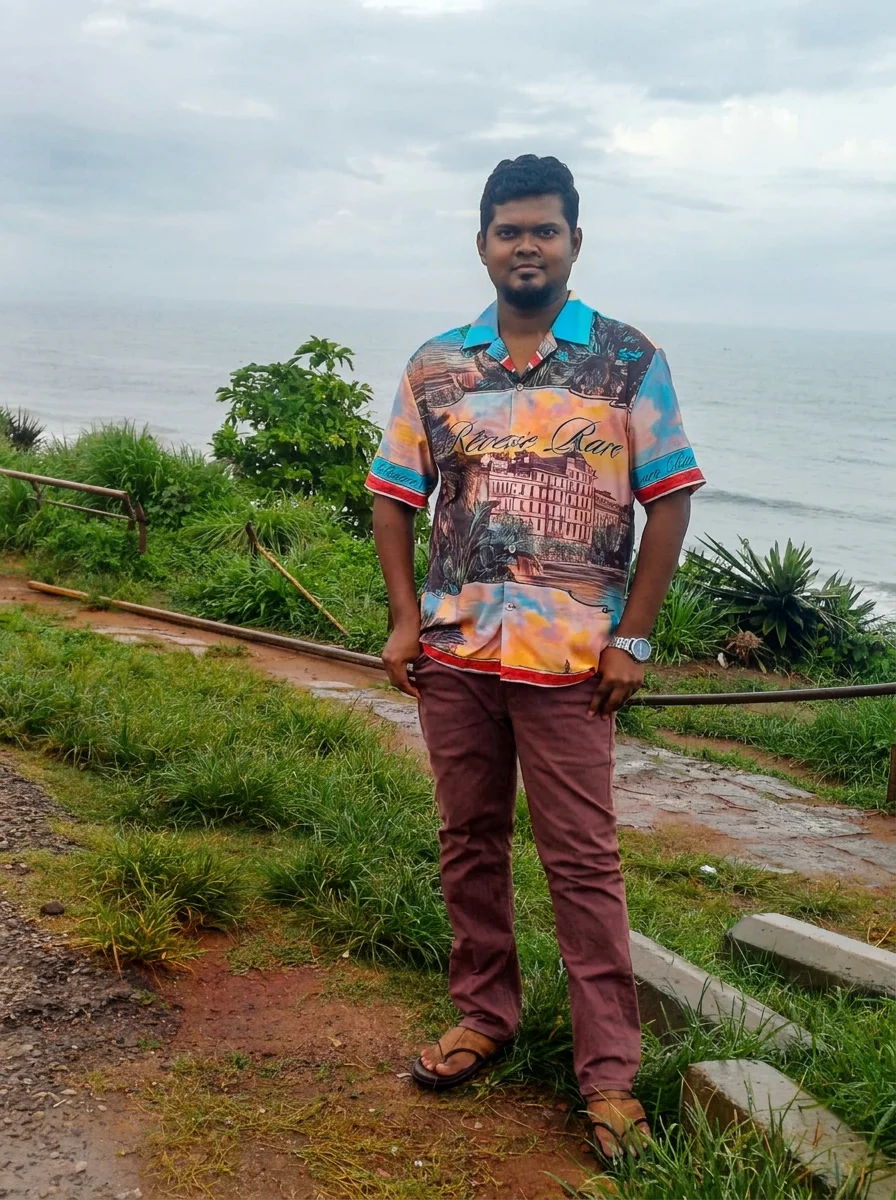 Jevon Max standing on a coastal path beside the sea