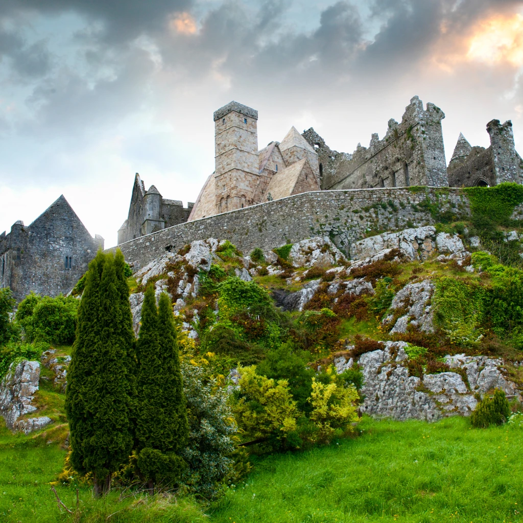 The Rock of Cashel medieval ruins above green fields in Ireland