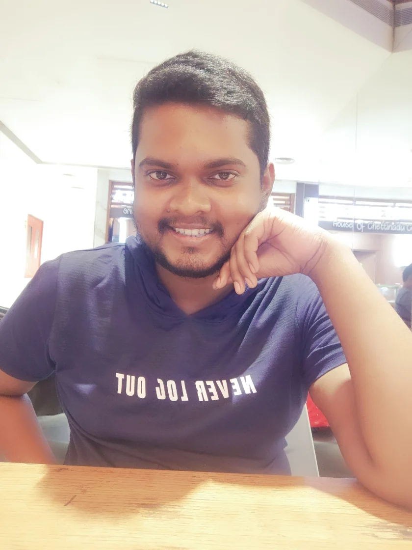 Jevon Max, founder of Zingy Trails, smiling at a cafe table in Chennai, India