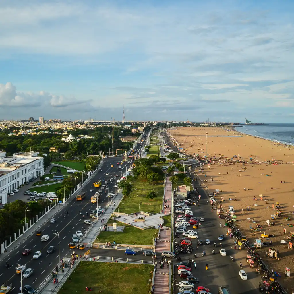 Marina Beach Chennai aerial view of the long beachfront road, traffic and sandy shore by the sea