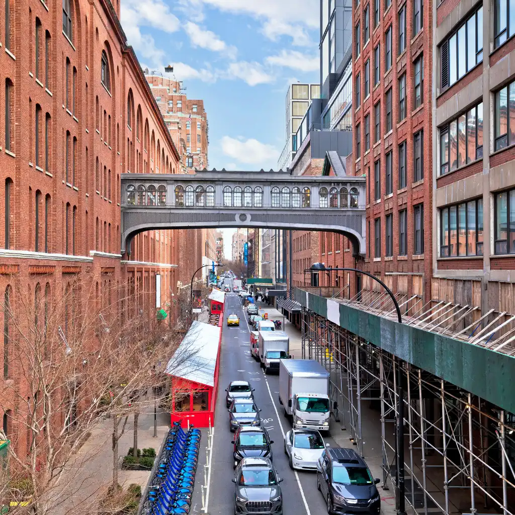 Meatpacking District New York High Line over busy street with cars and brick buildings