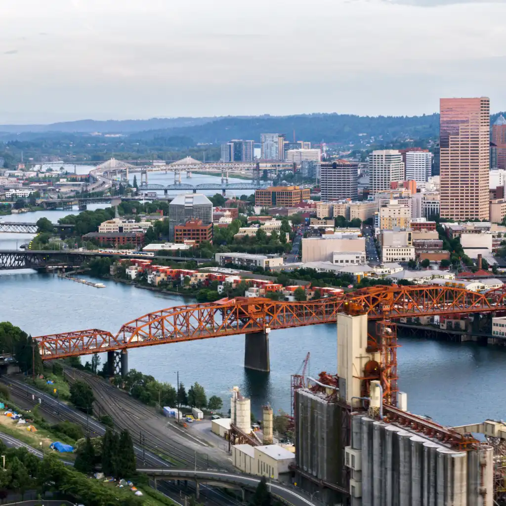 Downtown Portland skyline with orange bridge spanning the river and city buildings