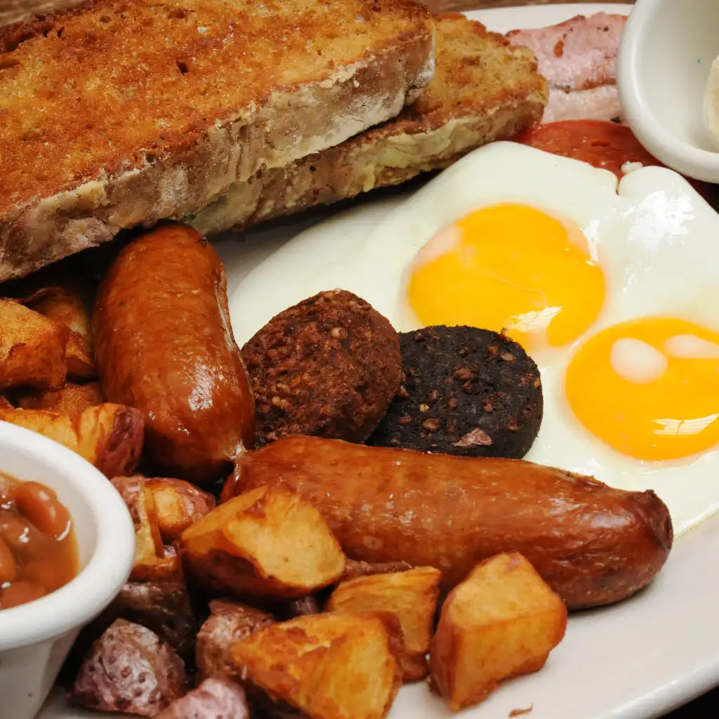Full Irish breakfast with eggs, sausages, black pudding, potatoes and beans after the rain