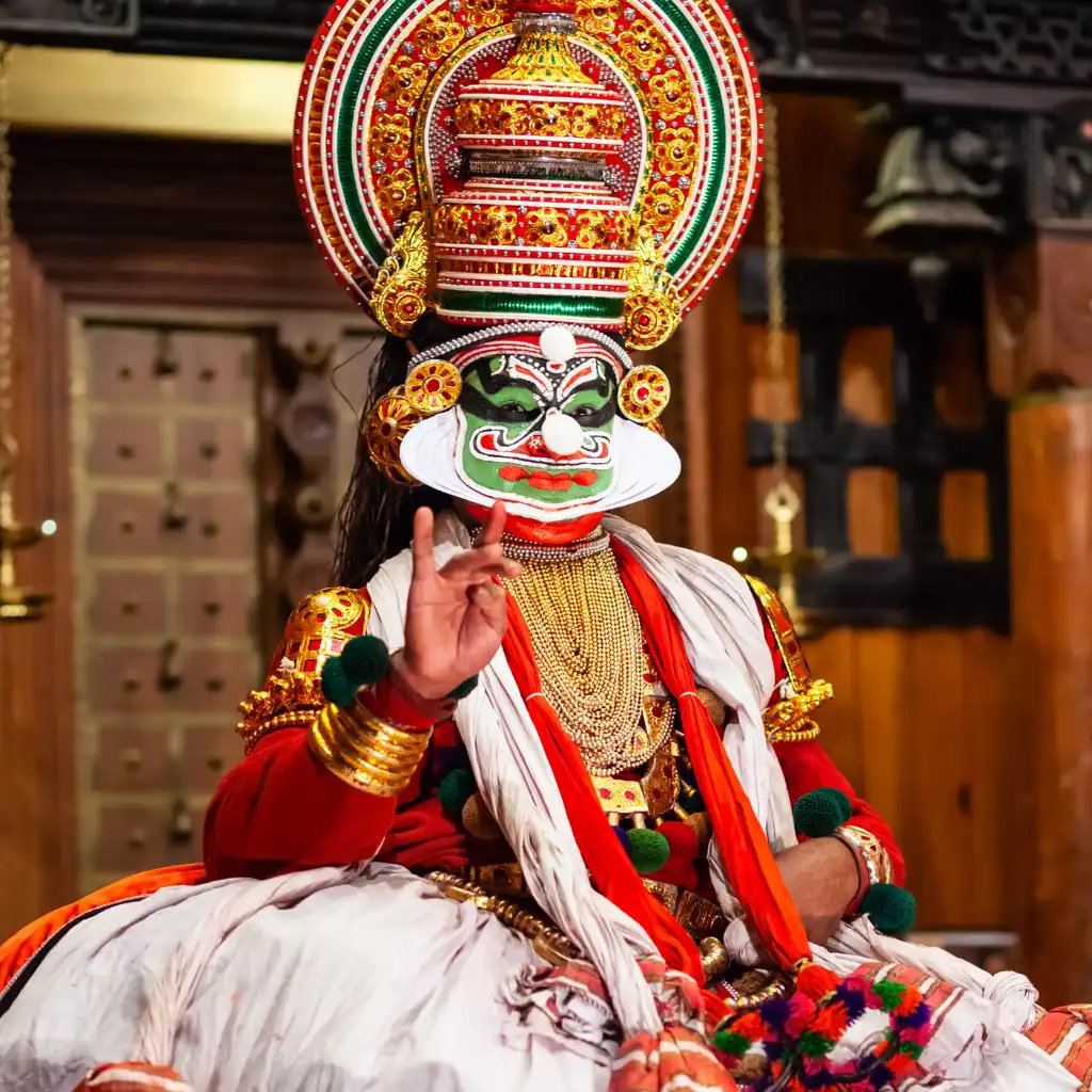 Kathakali Performance in Kochi with traditional headdress, vibrant makeup and expressive hand mudra
