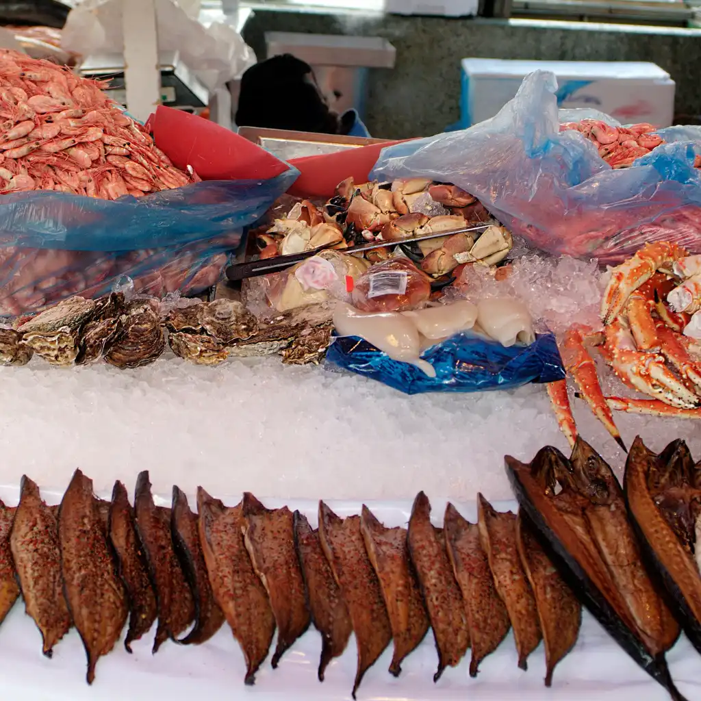 Norway seafood on ice with crab, oysters, squid and dried fish at market display