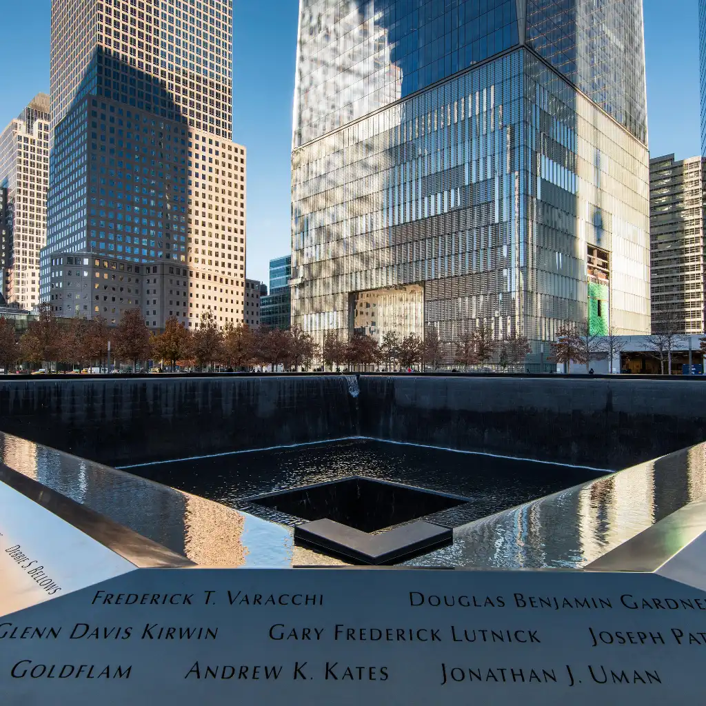 9/11 Memorial New York reflecting pools with inscribed names and surrounding skyscrapers
