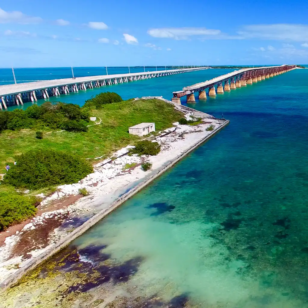 Bahia Honda Bridge over turquoise Florida Keys waters with green island and old rail span