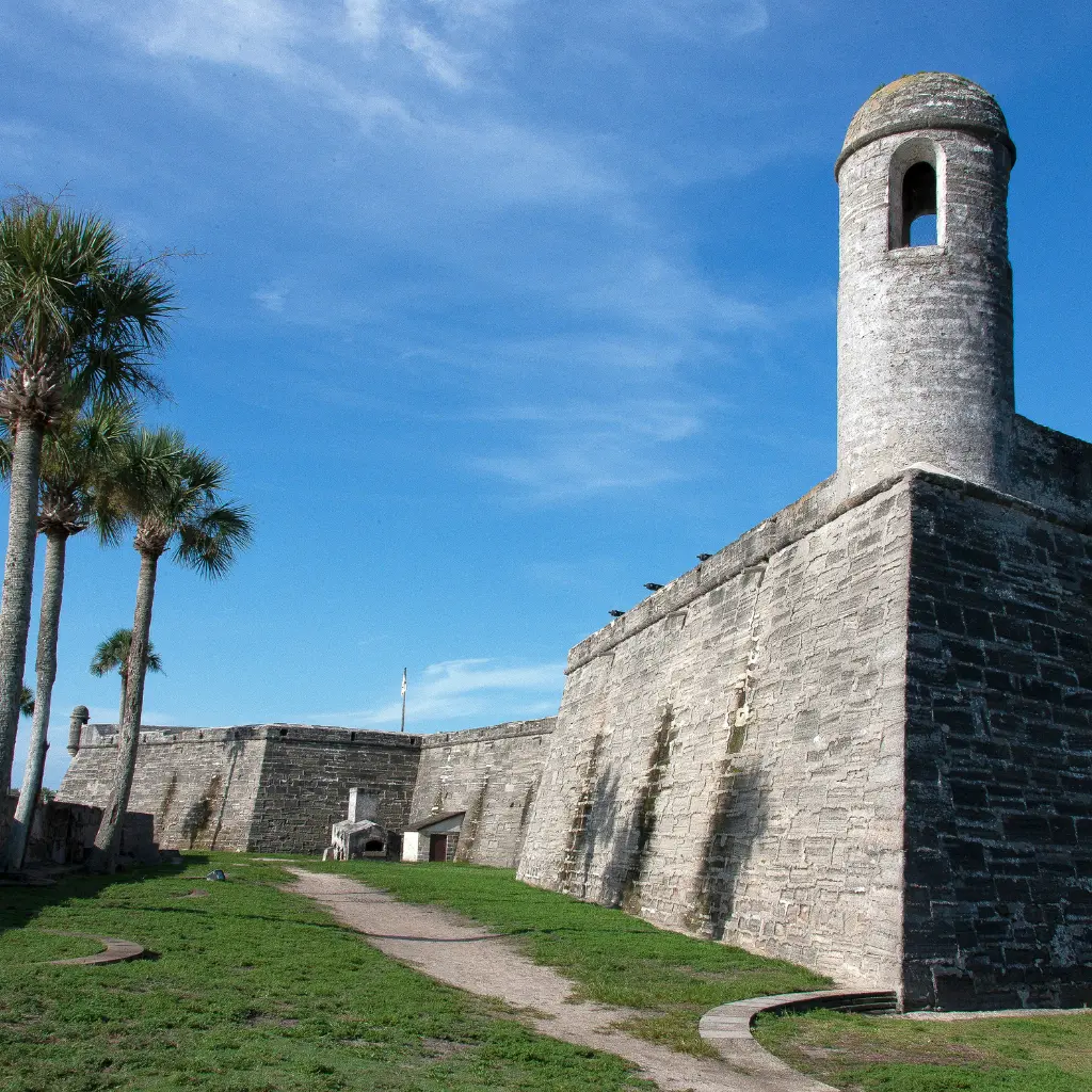 Castillo de San Marcos stone fort with round tower and palms in St. Augustine Florida