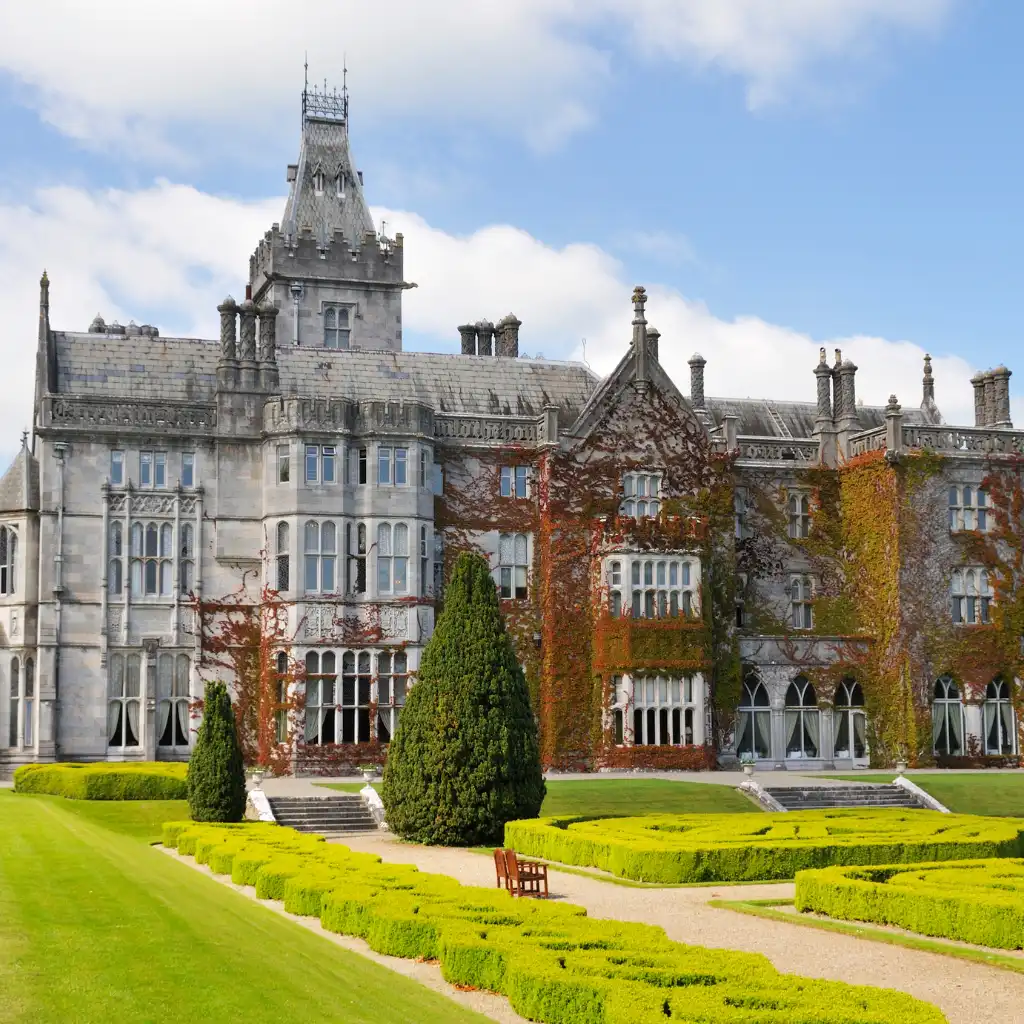 Historic Irish castle hotel with ivy walls, stone towers and formal gardens for a luxury stay