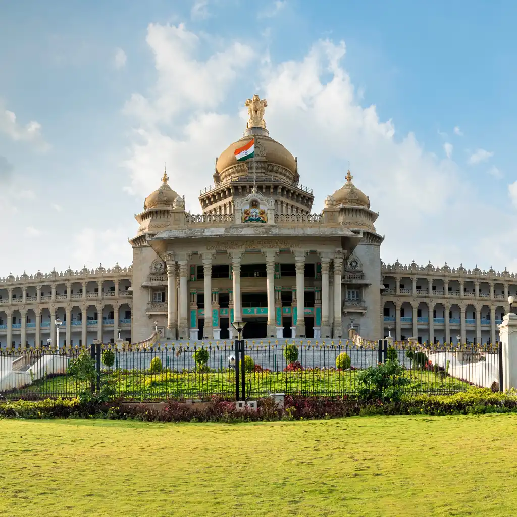 Vidhana Soudha Bengaluru grand facade with central dome Indian flag and lush gardens