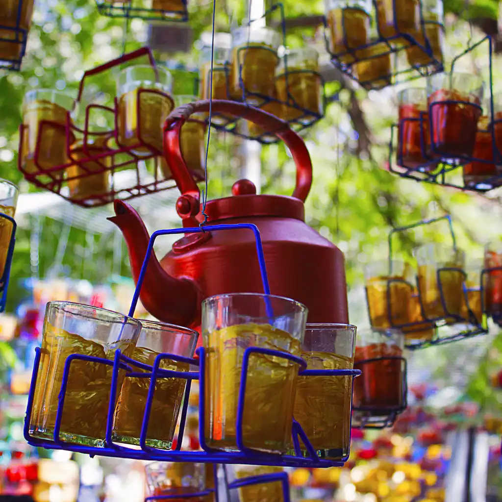 Kala Ghoda Mumbai chai stall with hanging tea glasses and red kettle in art precinct