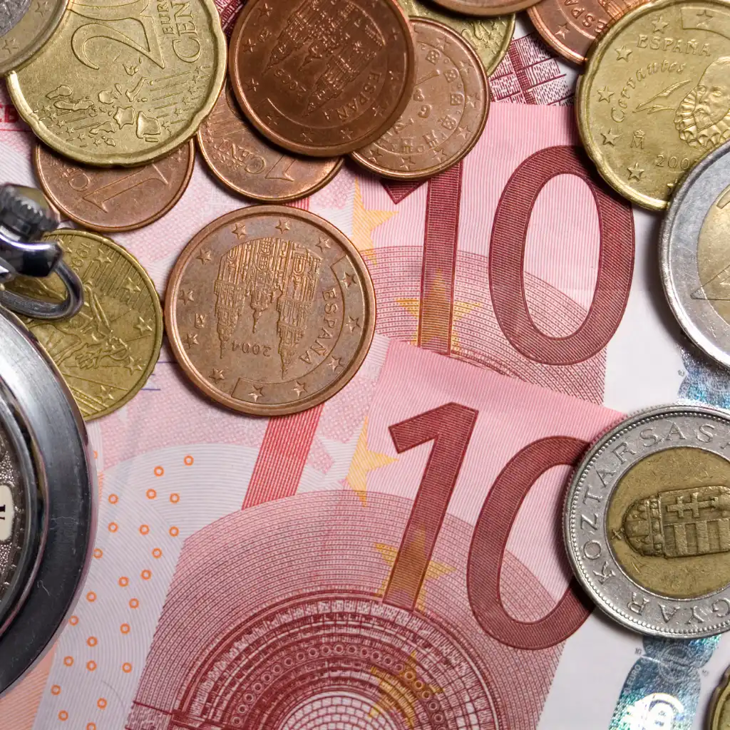Scotland trip cost shown with euro coins and 10 euro banknote on table