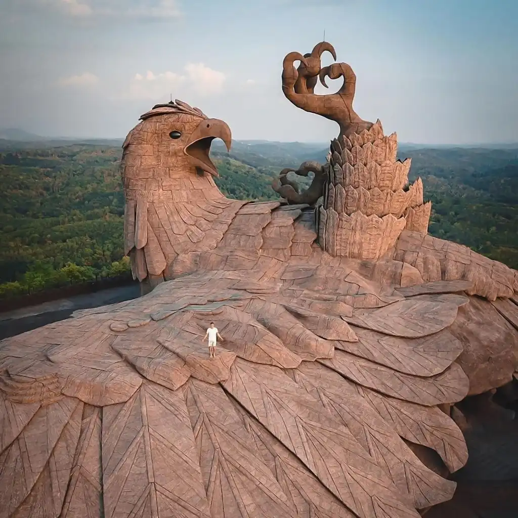 Jatayu Earth's Center, Kerala giant Jatayu statue with visitor on wing over green hills