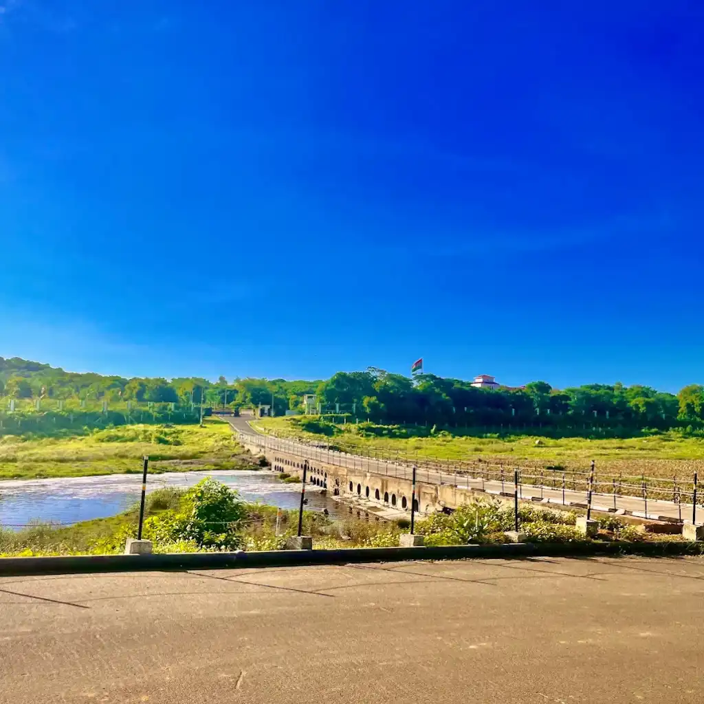ARB Adyar River Scenic Trail bridge over the river with green fields and hills in Chennai