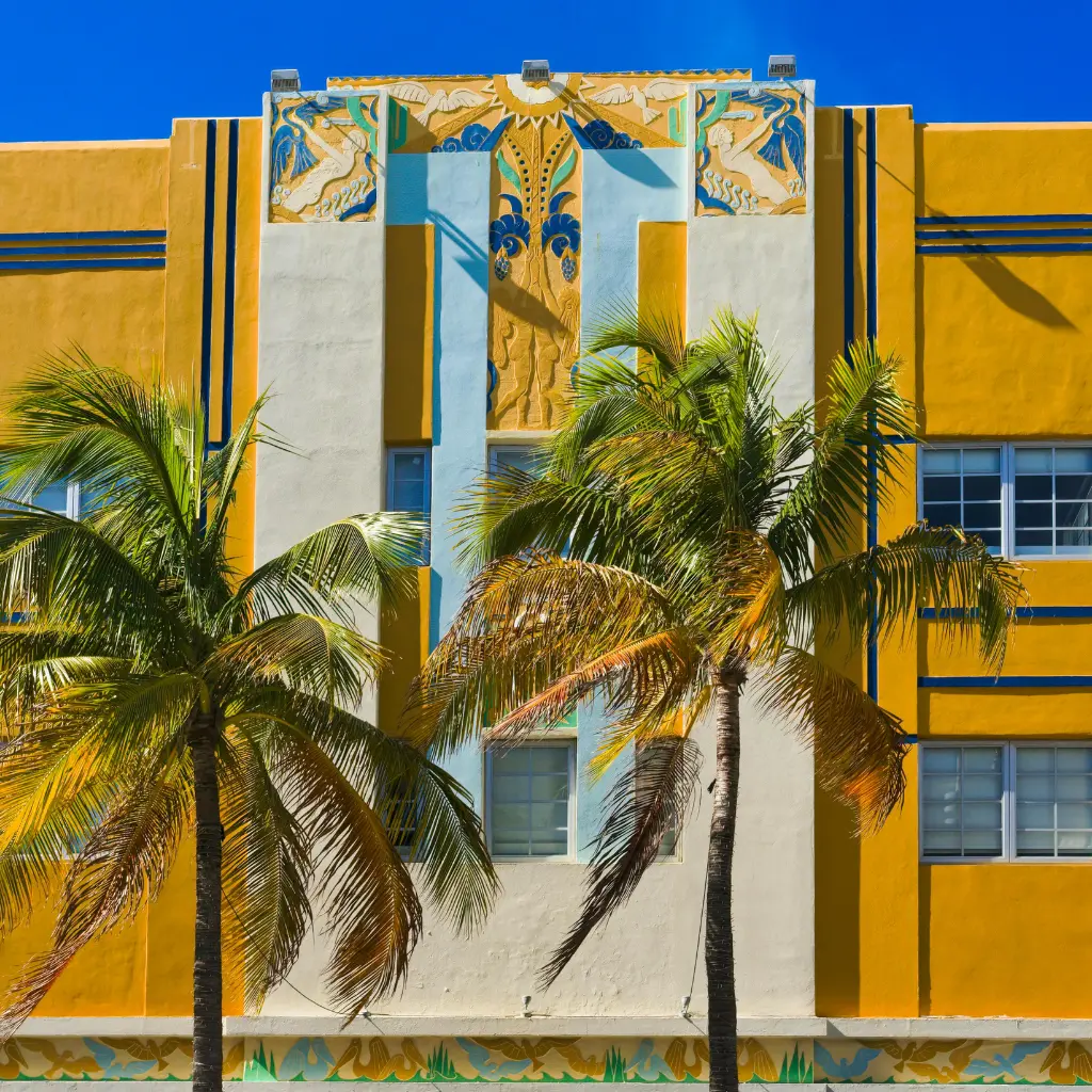 Ocean Five Hotel Miami Beach with yellow Art Deco facade and tropical palm trees
