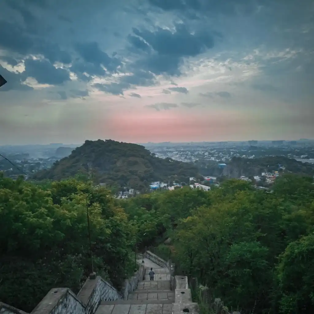 Pallavaram Mountain Chennai hike stairs overlooking city and green hills at dusk