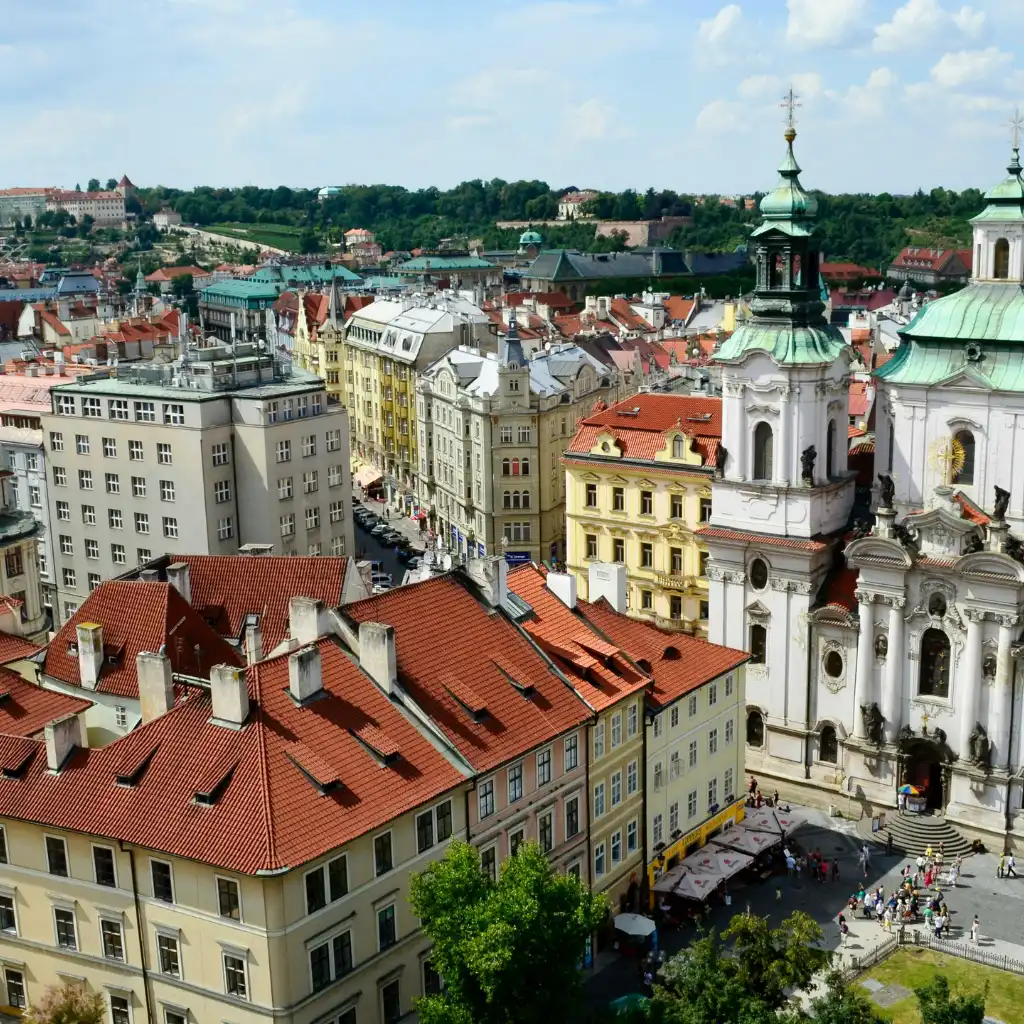 Old Town Square Prague panoramic view with red rooftops colorful buildings and ornate church towers