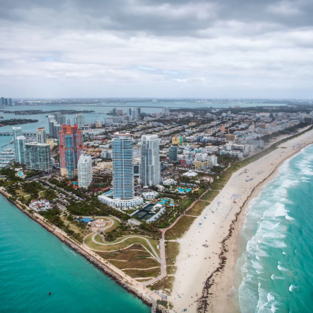 South Pointe Park Florida aerial view of beach, ocean waves and Miami skyline
