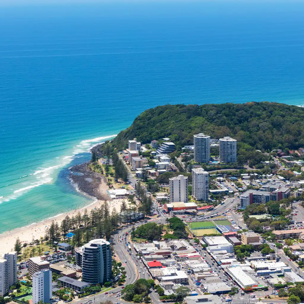 Burleigh Heads Gold Coast aerial view of headland, curving beach and coastal town with high-rises