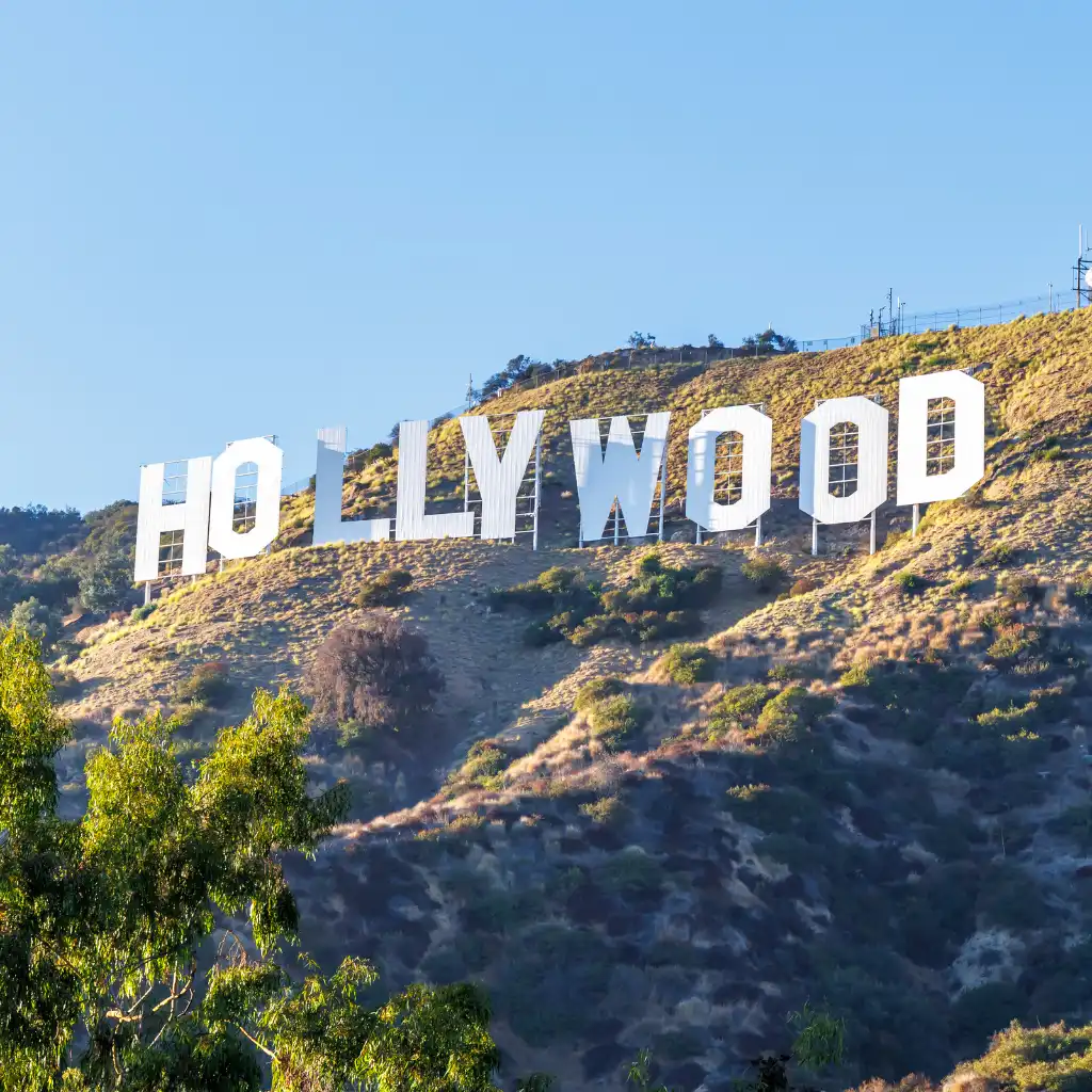 Hollywood Sign, Los Angeles on sunny hillside viewed from marked trail