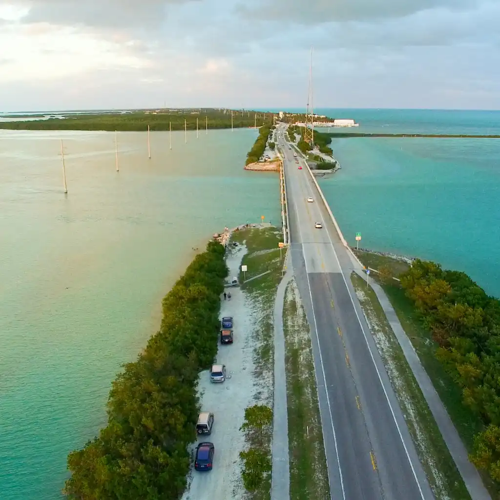 Islamorada Florida bridge on Overseas Highway with turquoise waters and parked cars on scenic road trip route