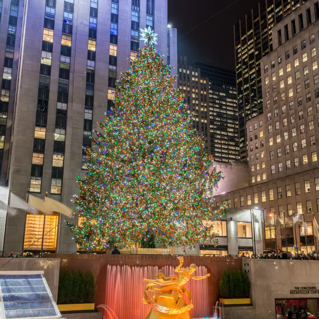 Christmas tree and Prometheus statue at 3 Rockefeller Plaza, New York at night