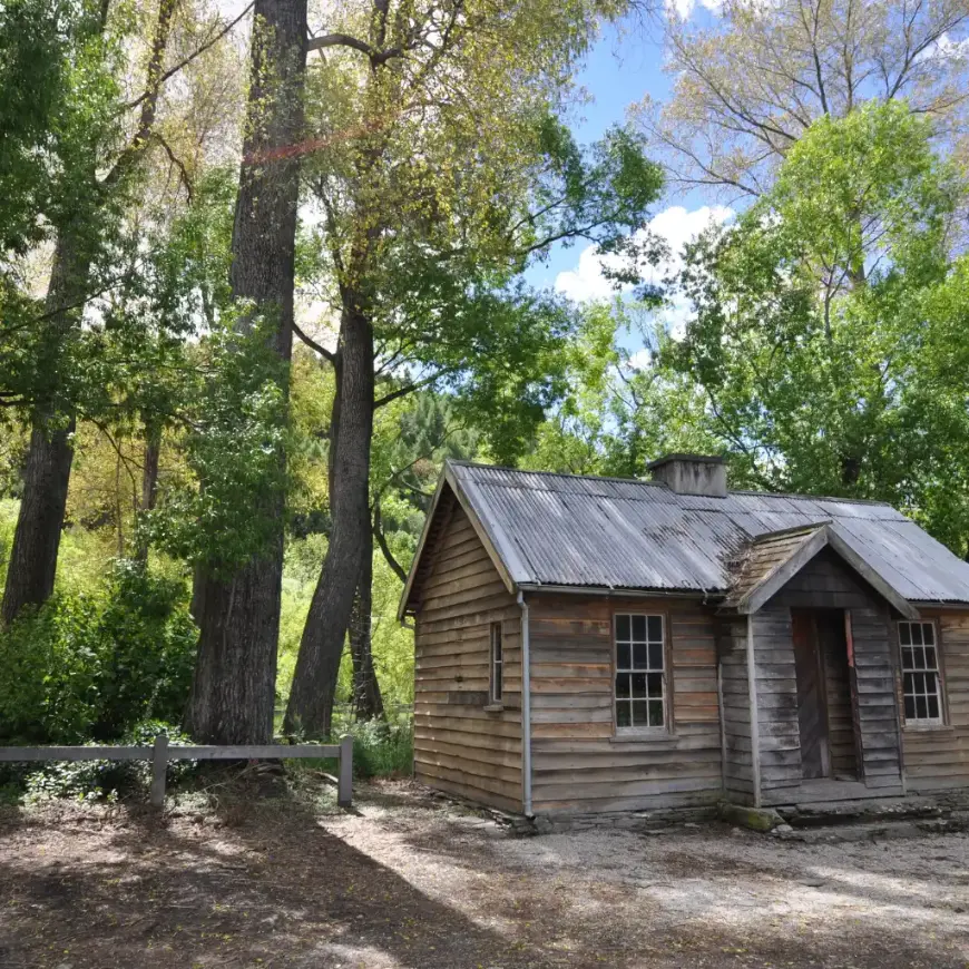 Arrowtown, Queenstown historic wooden cabin amid forest on gold-rush trail