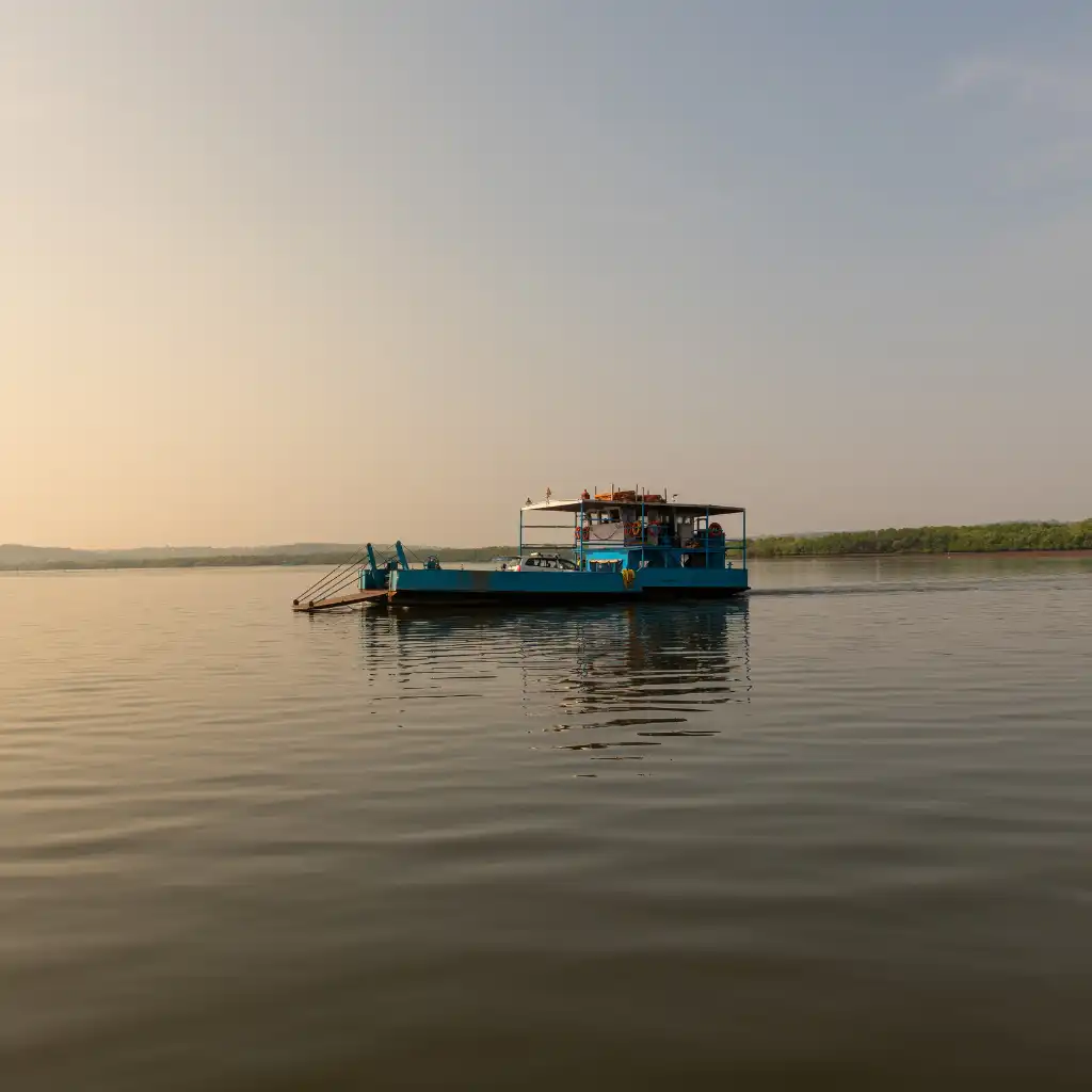 Blue ferry to Divar Island Goa on calm backwaters at dusk