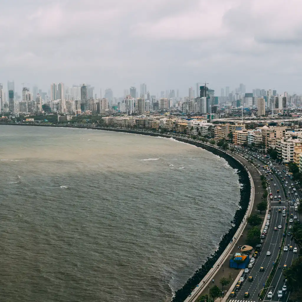 Marine Drive Promenade Mumbai aerial view of curved seafront road with traffic and skyline