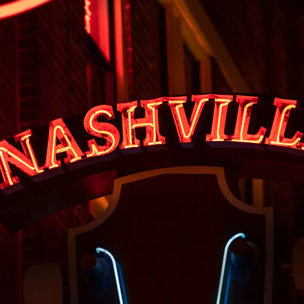 Neon Nashville sign glowing red at night in Nashville