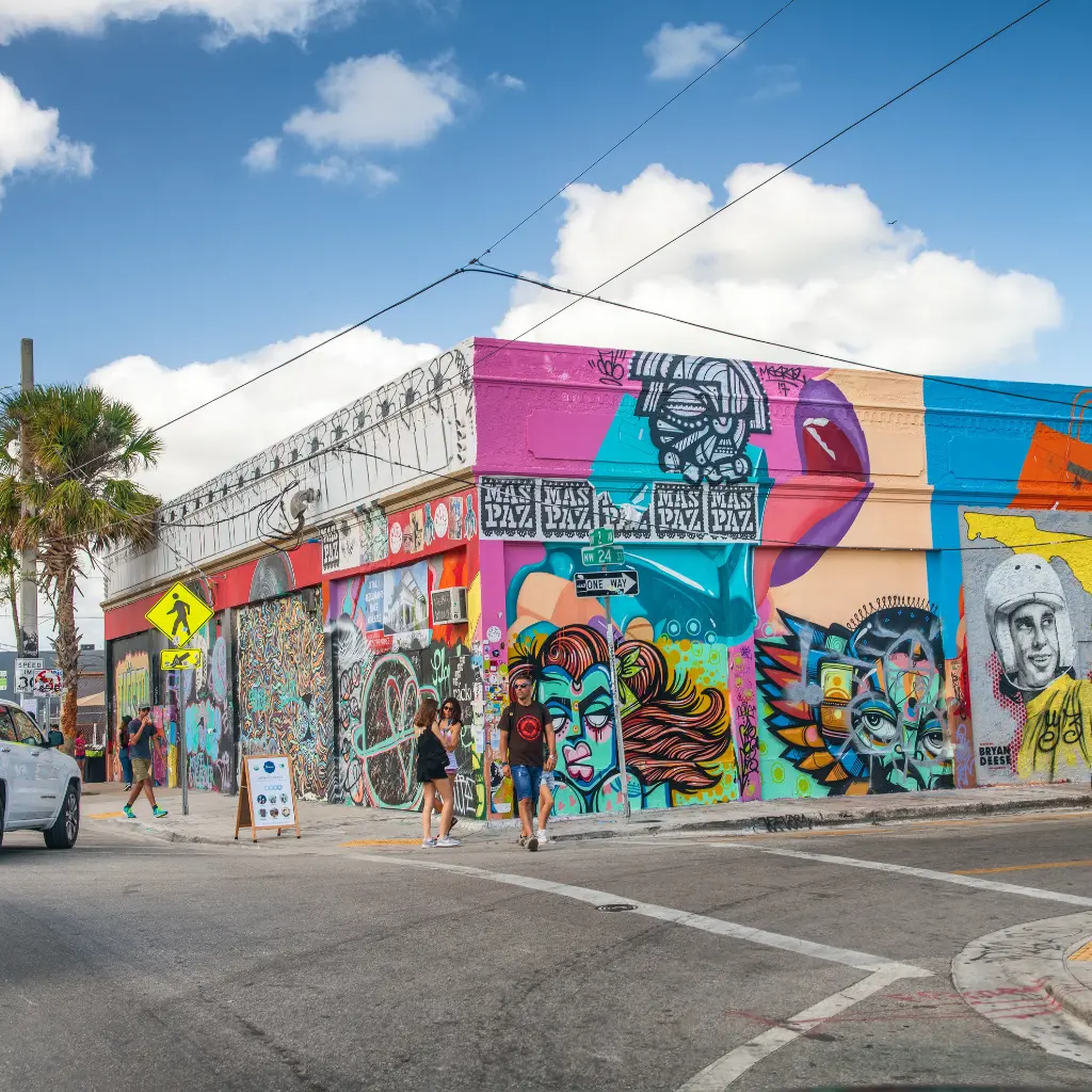 Wynwood Walls Florida colorful street art murals with pedestrians on a weekday in Miami