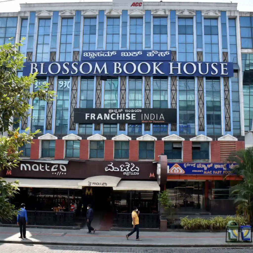 Blossom Book House Bengaluru exterior with Matteo coffee shop and pedestrians on Church Street