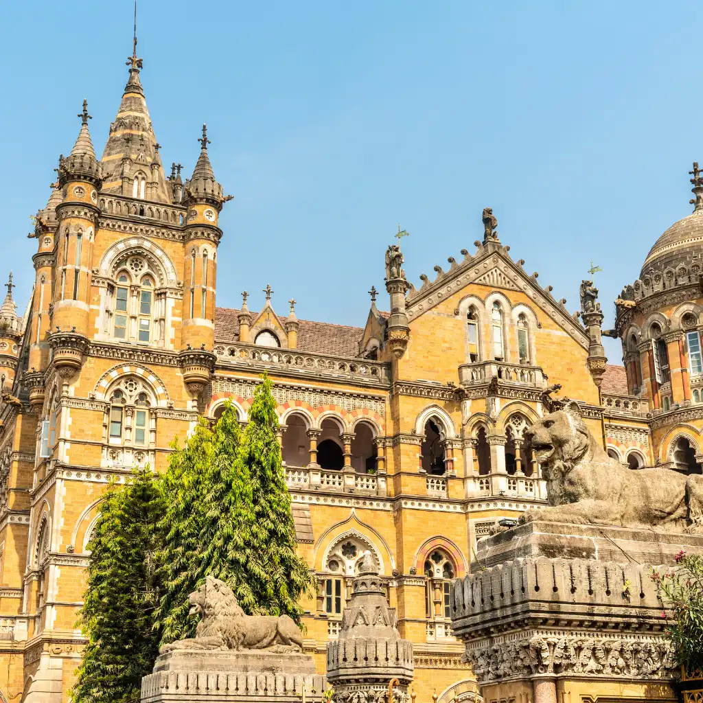 Chhatrapati Shivaji Maharaj Terminus Mumbai yellow Gothic facade with stone lion statues and towers