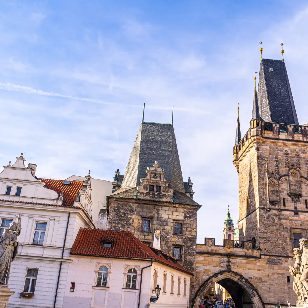 Old Town Bridge Tower, Prague Gothic spire above stone archway and red-roofed buildings