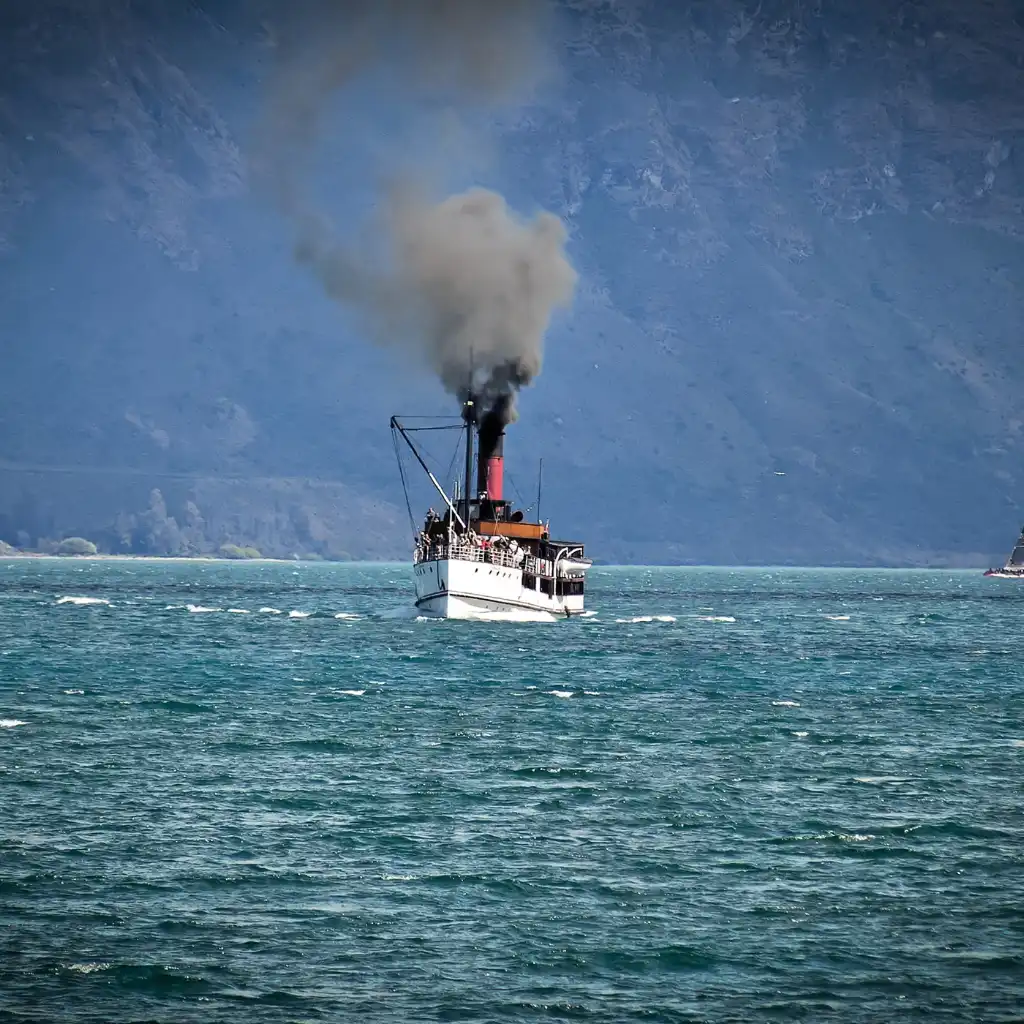TSS Earnslaw Queenstown steaming across Lake Wakatipu on a scenic cruise with mountain views