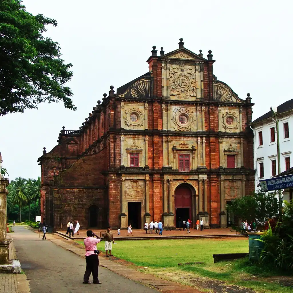 Basilica of Bom Jesus Goa ornate facade with tourists on the lawn