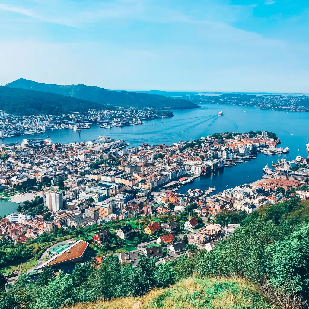 Bergen harbor and Bryggen viewed from Fløyen Norway with cityscape and fjord mountains