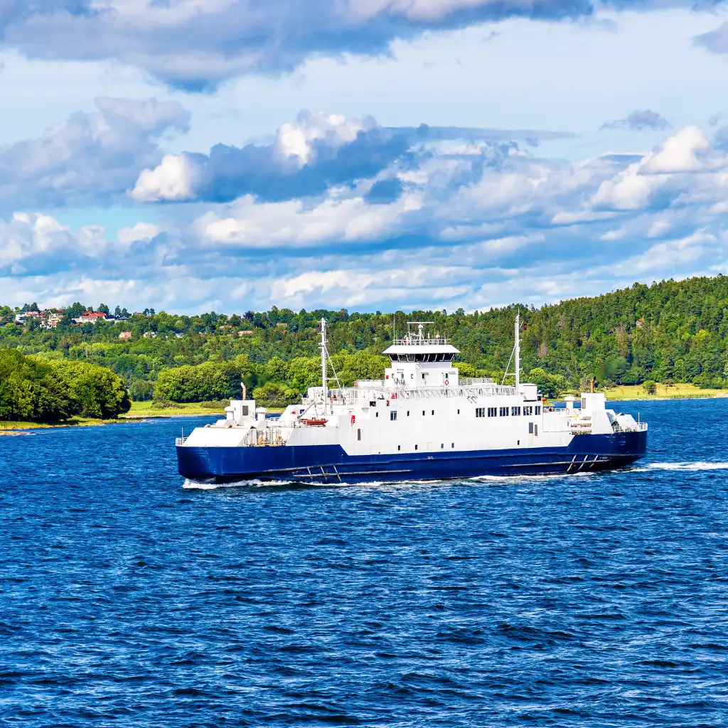 Oslofjord cruise ferry sailing past lush green coastline on Norway's scenic waters