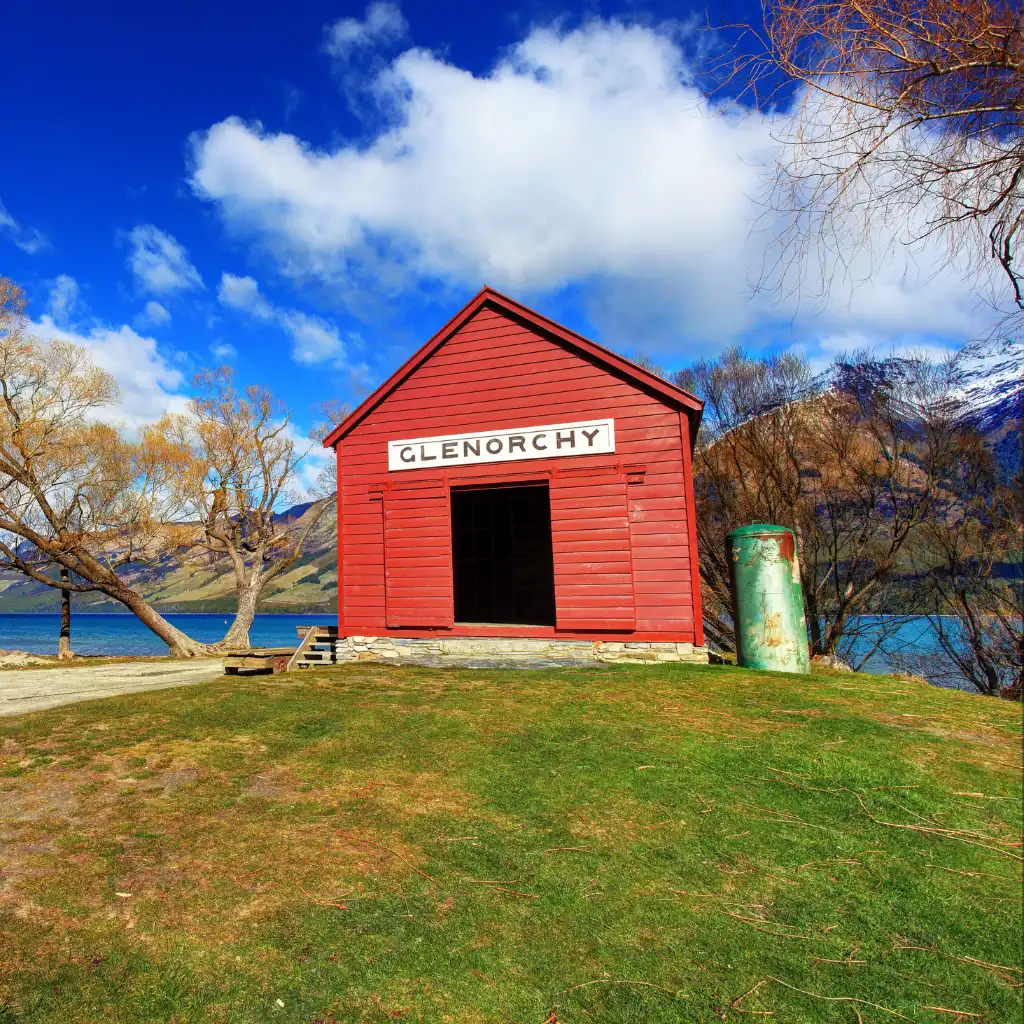 Glenorchy red building by lake with mountain views Queenstown New Zealand
