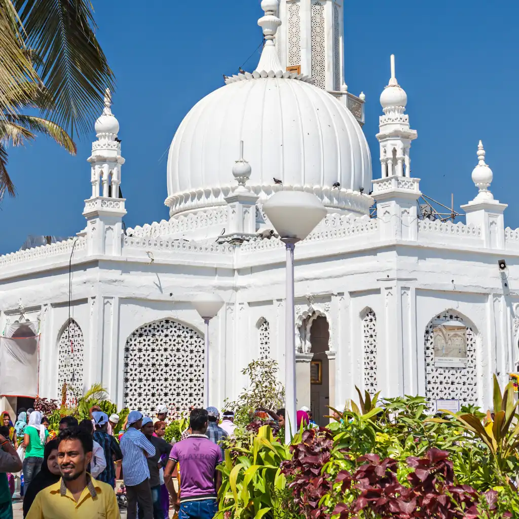 Haji Ali Dargah Mumbai white domed mosque with visitors and gardens