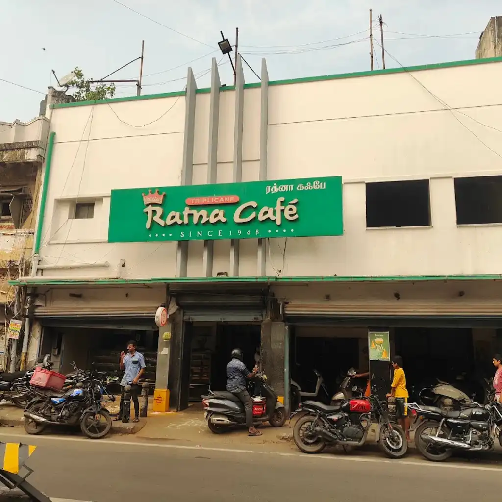 Ratna Cafe Triplicane Chennai exterior with green sign motorcycles and locals outside since 1948