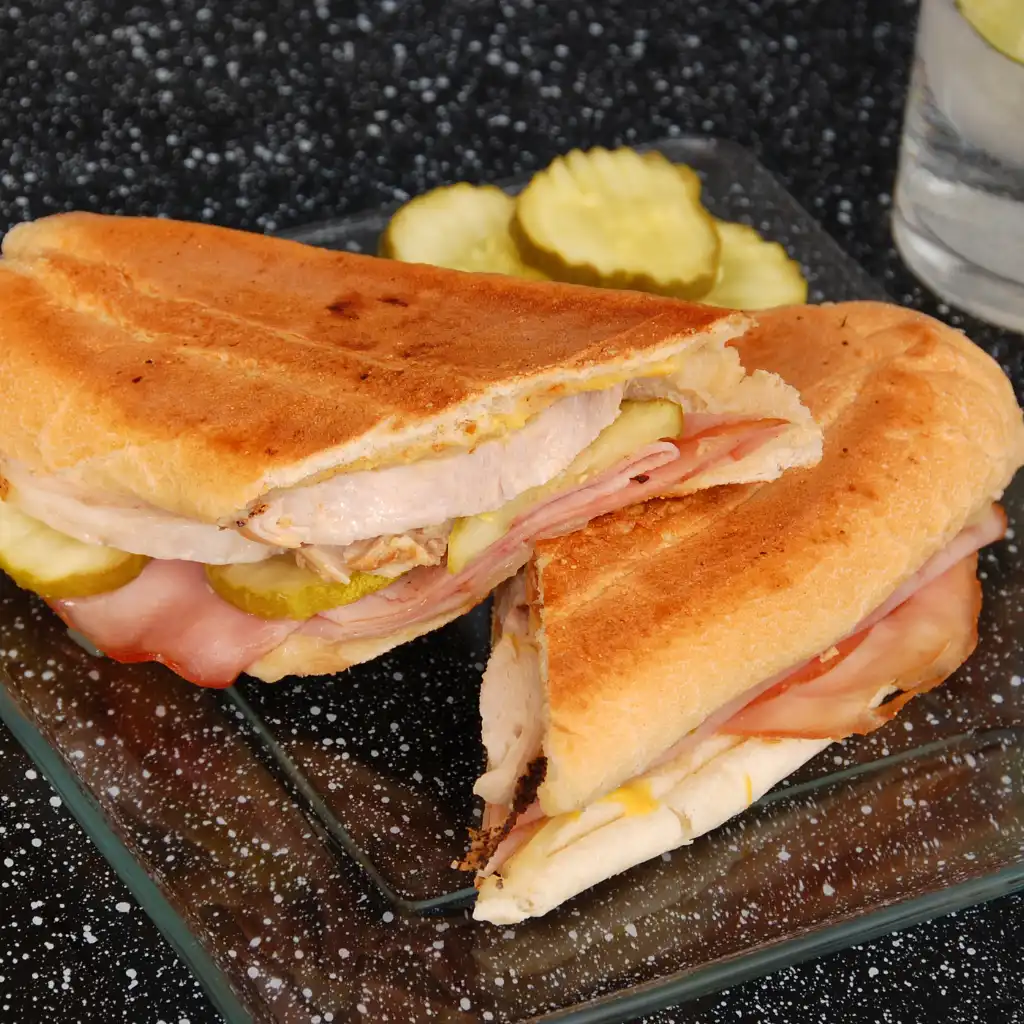 Cuban sandwich with ham, pork and pickles on pressed bread, Florida table food