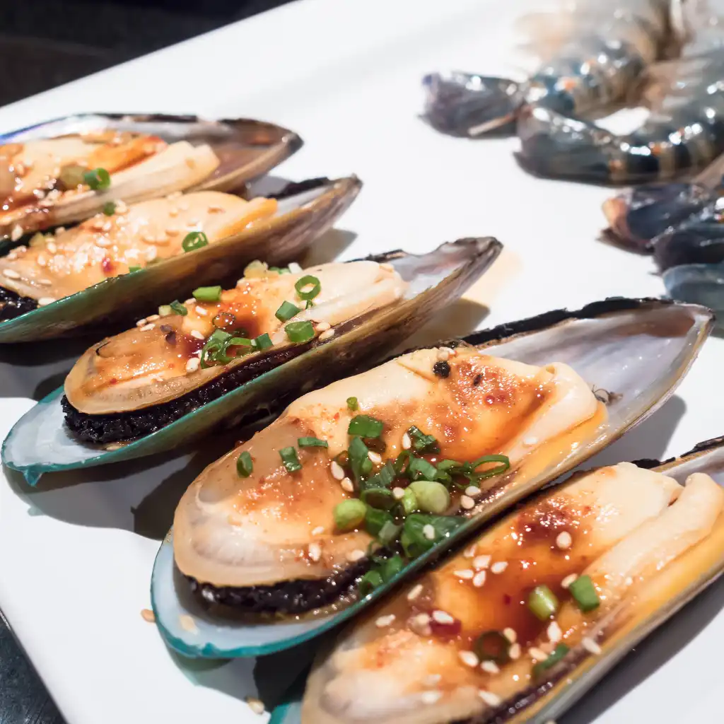 New Zealand Seafood mussels with green onions and sesame plated near Queenstown lake
