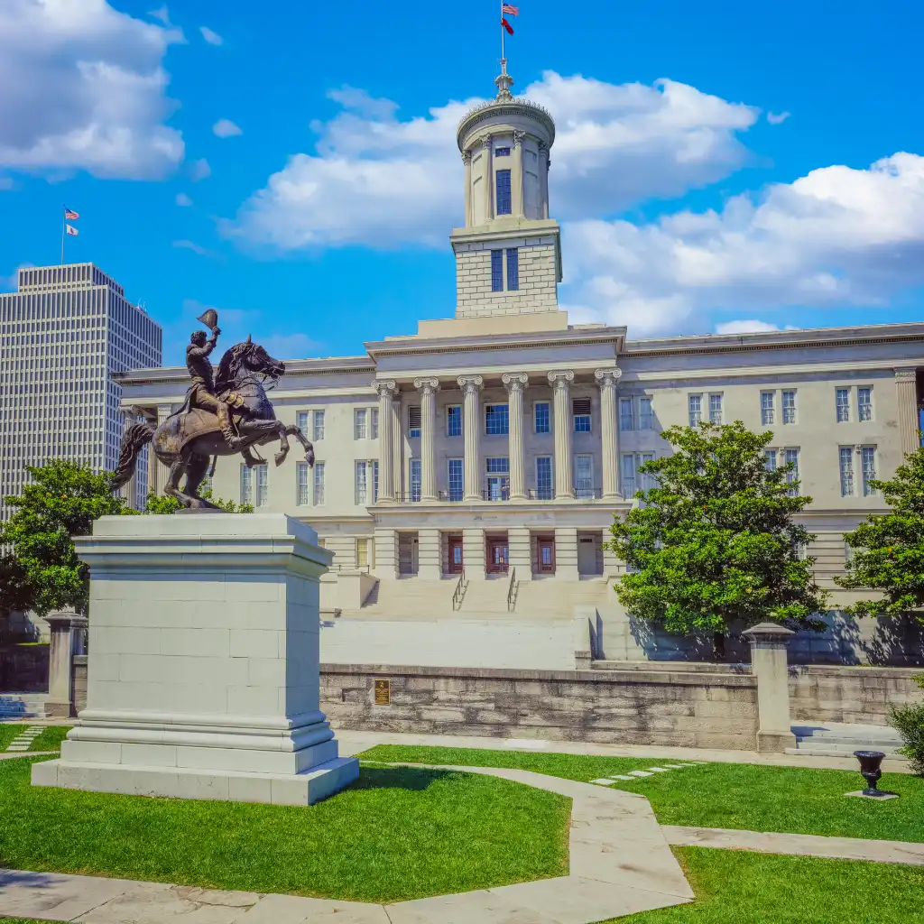 State Capitol, Nashville with equestrian statue on green lawn before neoclassical building