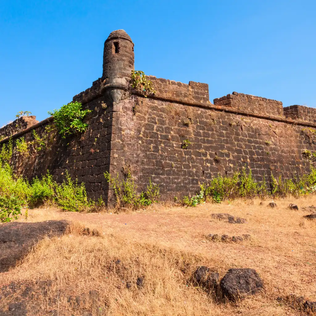 Chapora Fort Goa stone walls and bastion with dry grass foreground