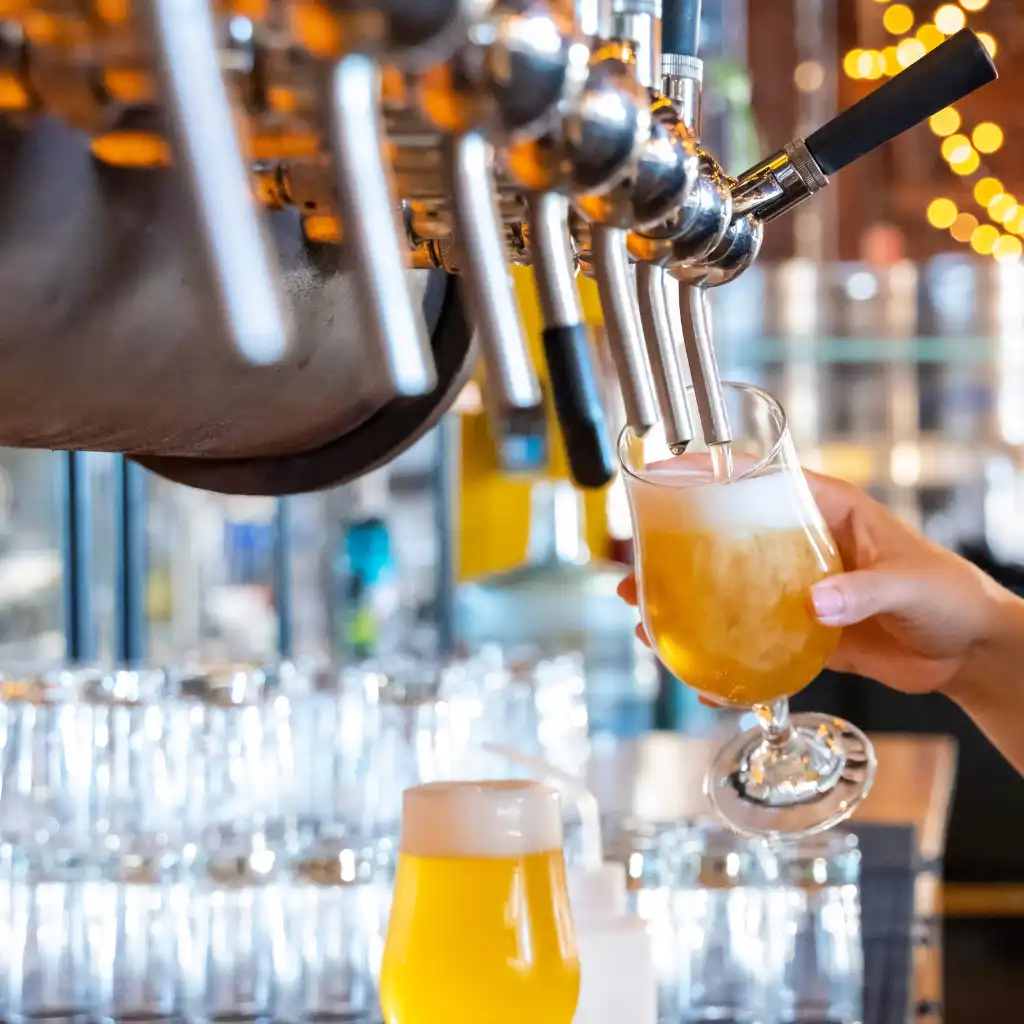 Craft beer poured from tap into glass at Indiranagar Bengaluru bar