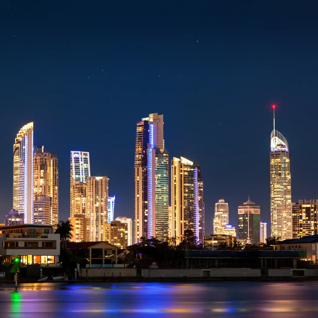 Surfers Paradise Gold Coast skyline glowing at night with lights reflecting on water