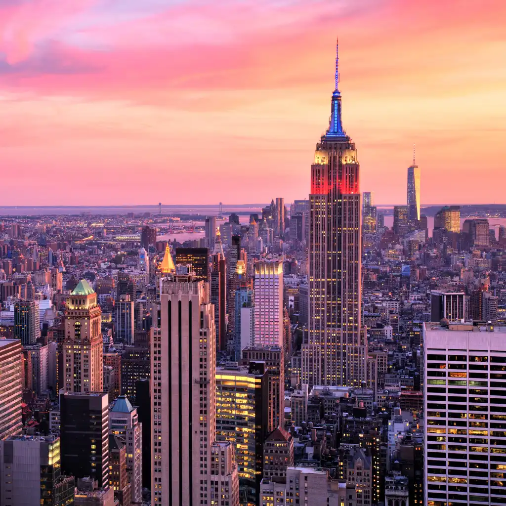 Empire State Building glowing at sunset over New York City skyline