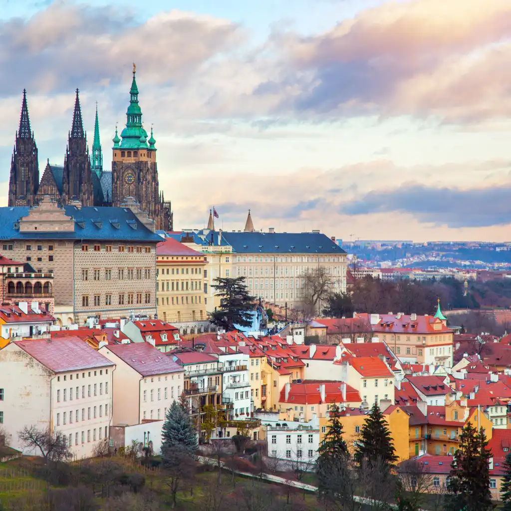 Prague Panorama with Prague Castle overlooking red-roofed city buildings at sunset